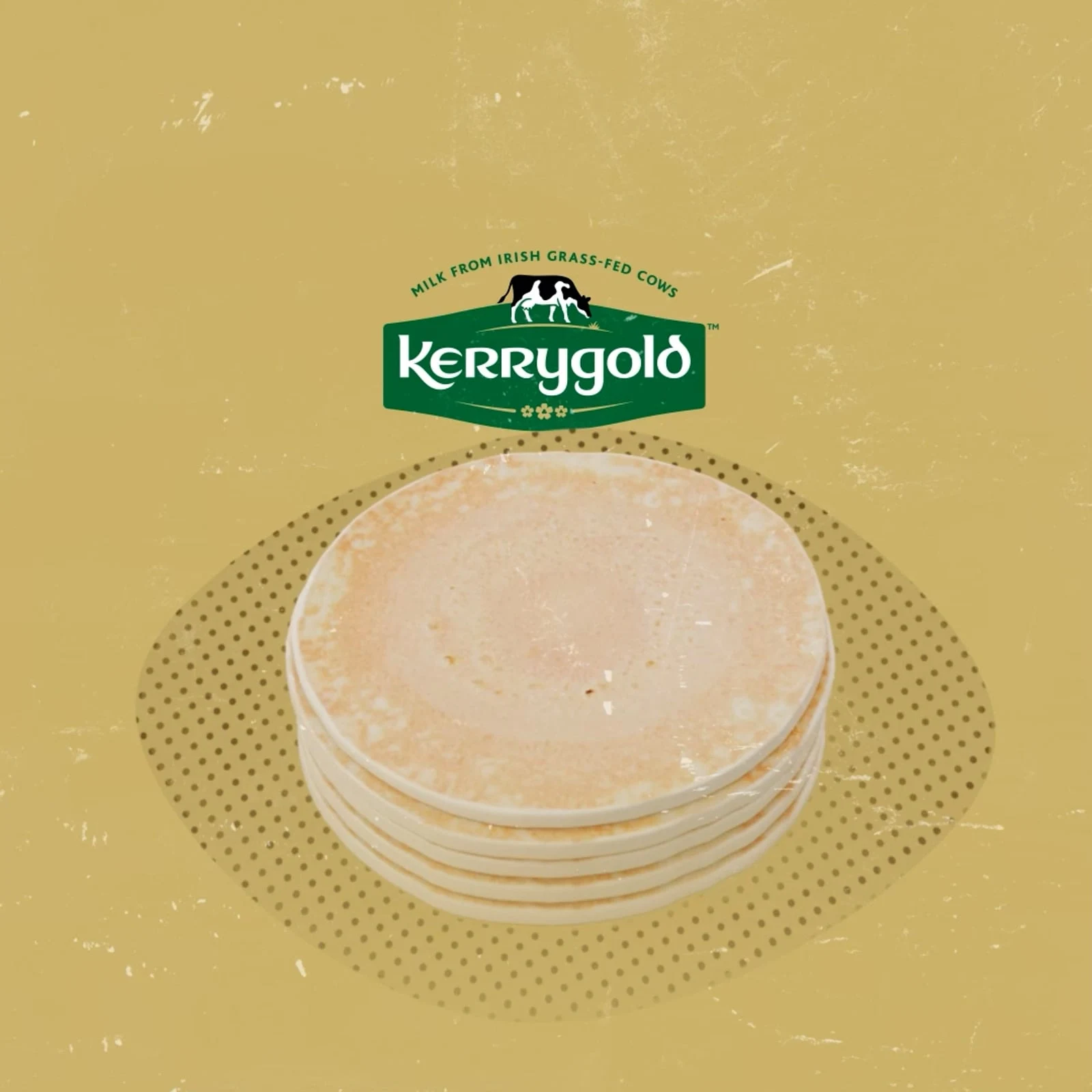 A stack of pancakes beneath the Kerrygold logo on a warm gold background